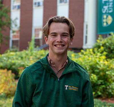 Student Ethan Nylen standing on campus in front of George Martin Hall