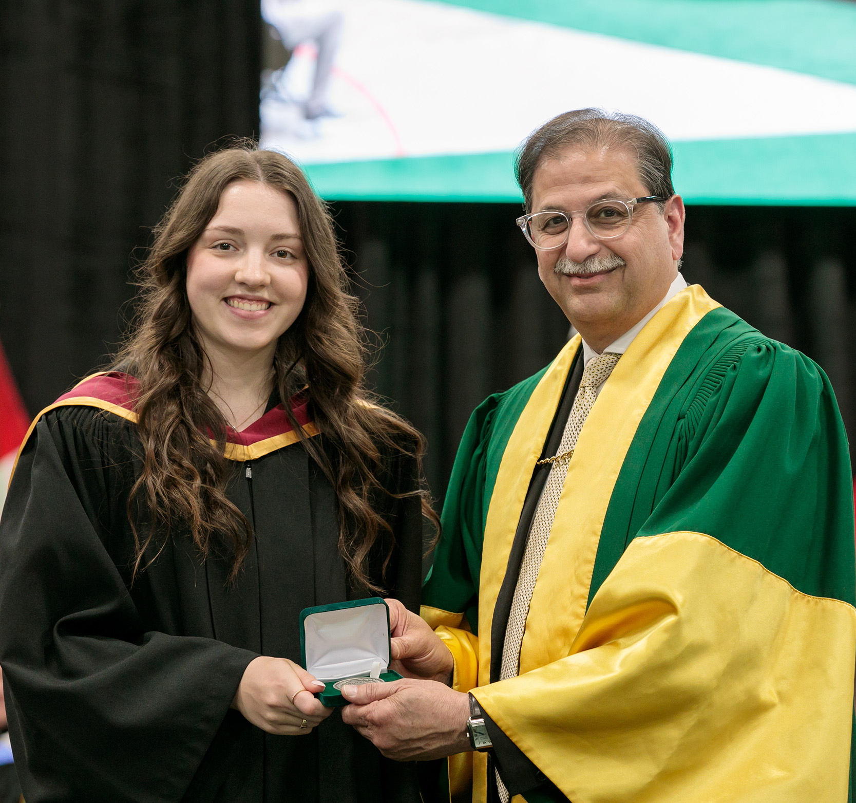 President Farooqi presents Michaela Hansen with the University Medal for Arts at Spring Convocation