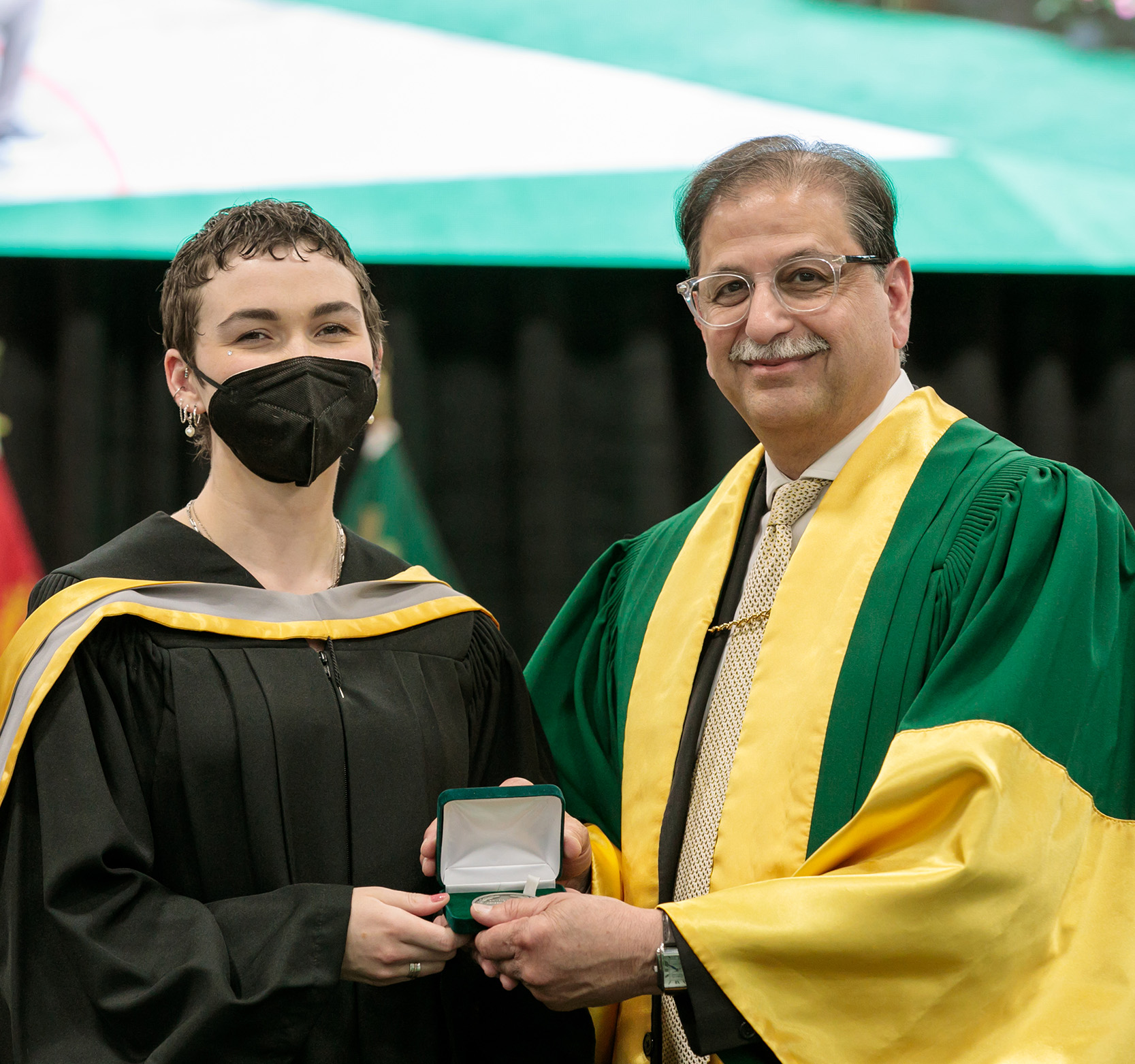 President Farooqi presents Shelby Harnish with the Medal for Social Work at Spring Convocation