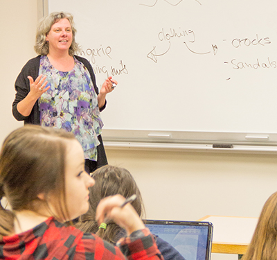 Professor Dr. Monkia Stelzl standing in front of a white board, teaching a class.