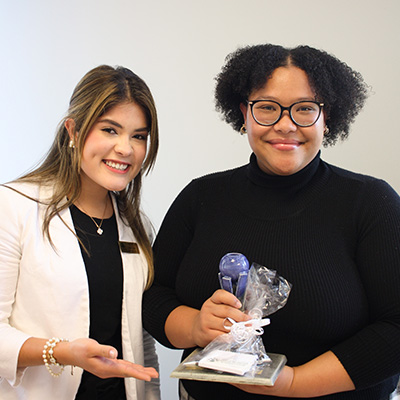 STUdent Chante Laverlot (right) is presented with the FutureNB Student Excellence Award by Internships Coordinator Ale Navas (left)