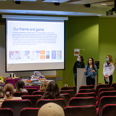 Three students giving a presentation in class