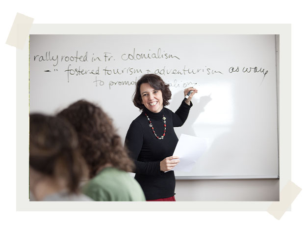 Dr. Karen Robert teaching a class and writing on whiteboard